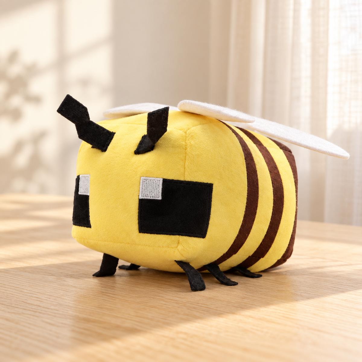 Yellow pixel bee plush with white wings and dark stripes