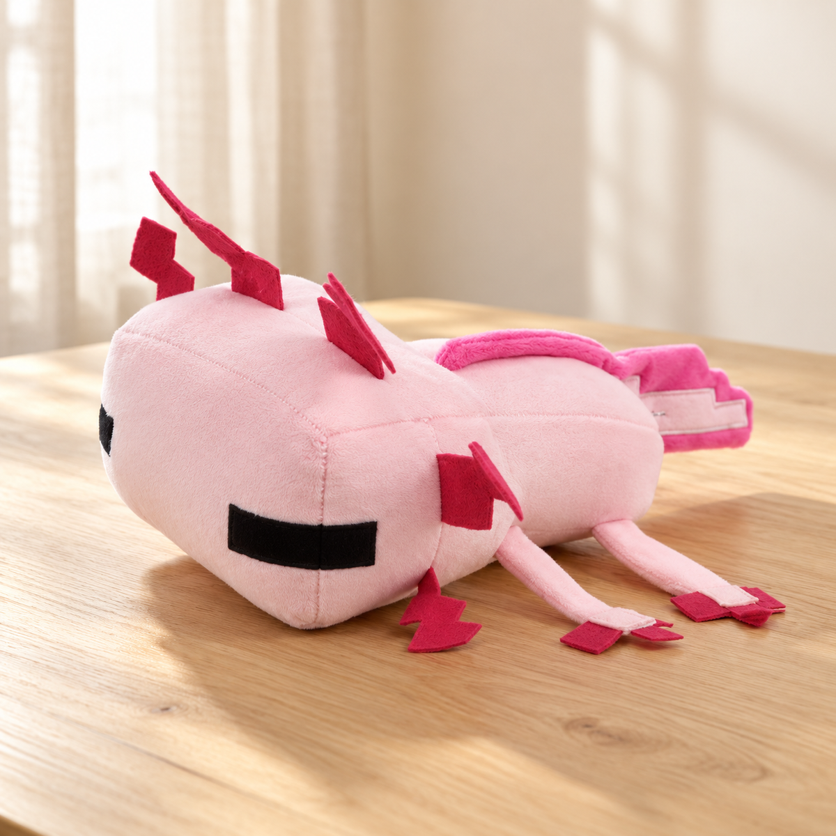 Pink pixel axolotl plush with angular gills and long tail