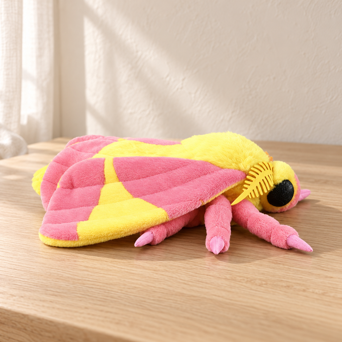 Vesper Rosy - 24 cm moth and insect plush on a pale oak table