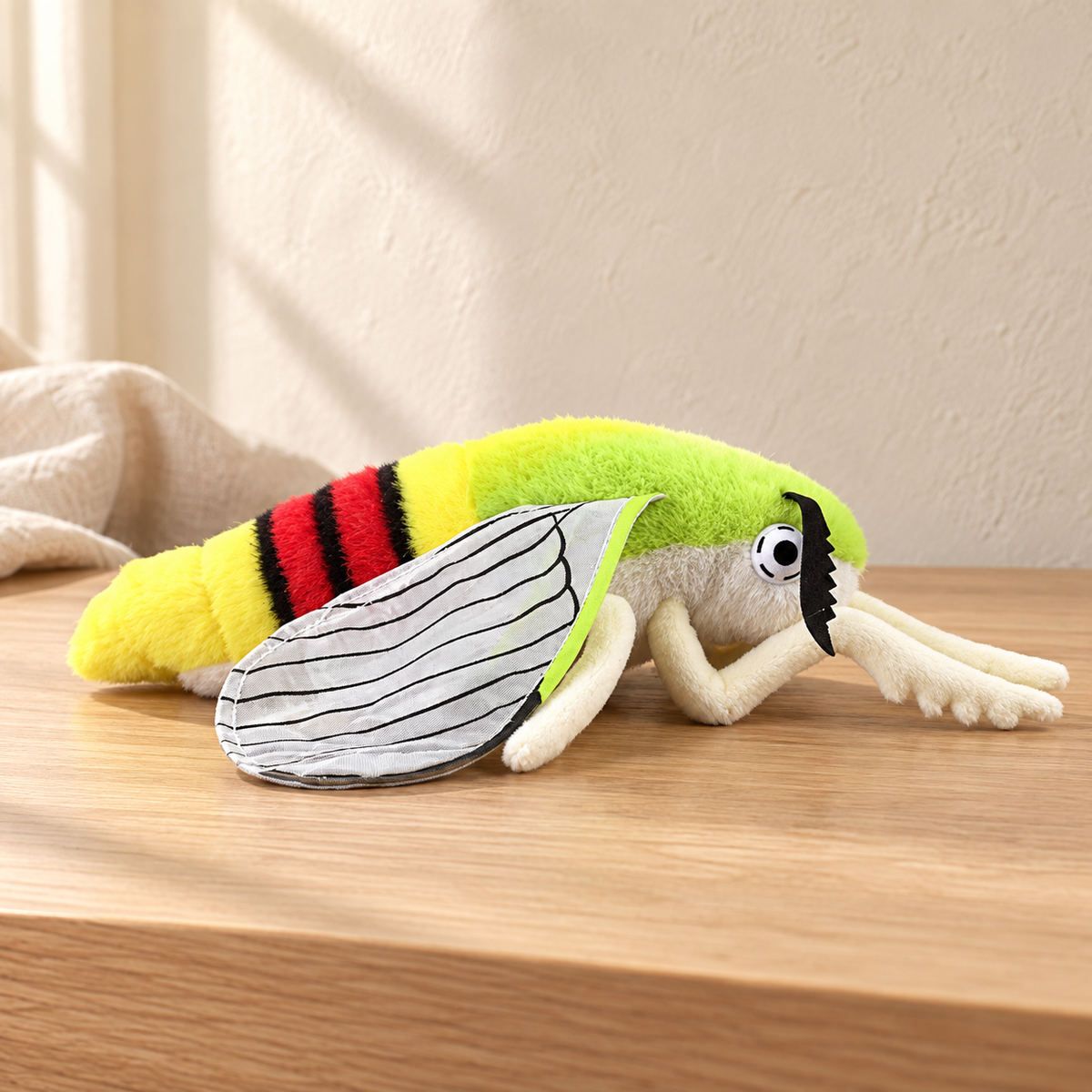 Vesper Green Stripe - 23 cm moth and insect plush on a pale oak table