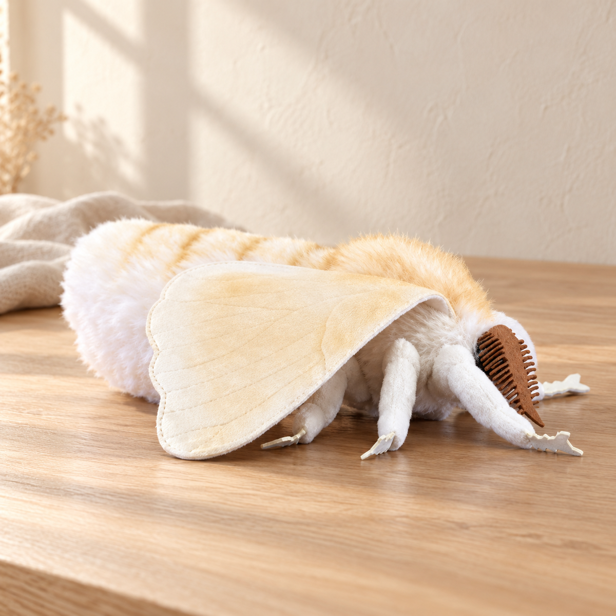Vesper Vanilla - 22 cm moth and insect plush on a pale oak table